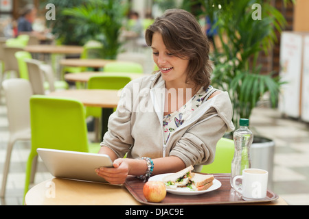 Woman using tablet PC in the cafeteria Stock Photo