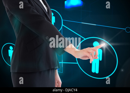 Composite image of businesswoman pointing on glowing futuristic blue background Stock Photo