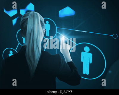 Composite image of businesswoman pointing on glowing futuristic blue background Stock Photo
