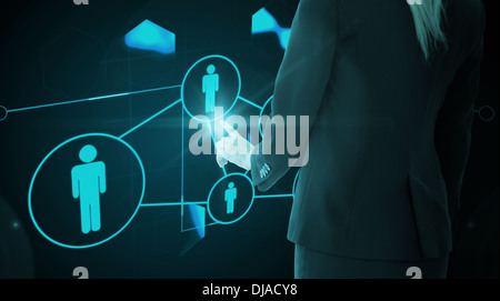 Composite image of businesswoman pointing on glowing futuristic blue background Stock Photo