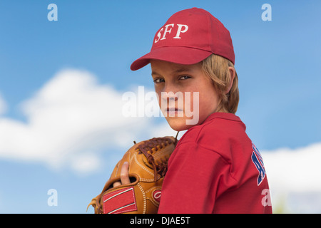 Caucasian boy playing baseball outdoors Stock Photo