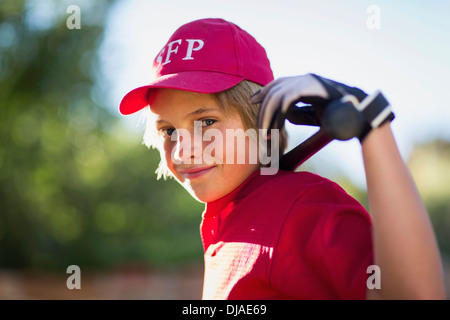 Caucasian boy playing baseball outdoors Stock Photo