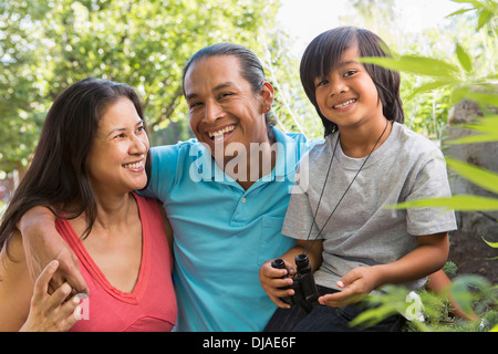 Family smiling outdoors Stock Photo