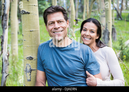 Couple smiling in forest Stock Photo