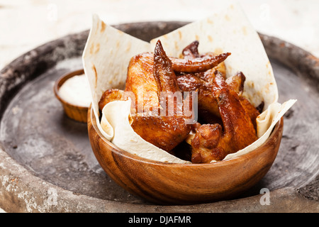 Fried Chicken Wings in wooden bowl Stock Photo