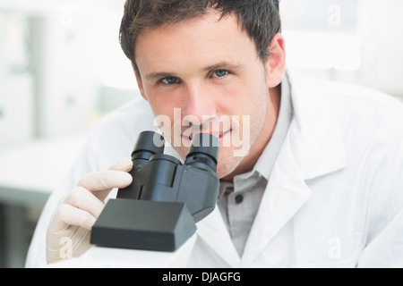 Scientific researcher using microscope in the laboratory Stock Photo