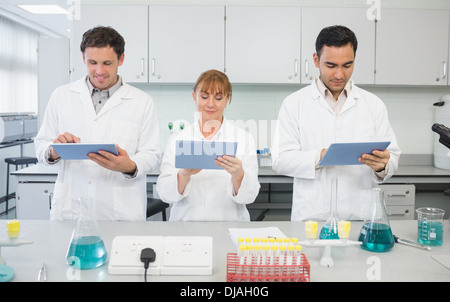 Scientists using tablet PCs in the lab Stock Photo