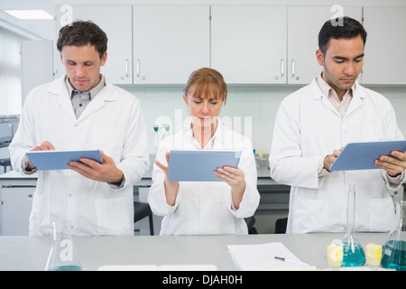 Scientists using tablet PCs in the lab Stock Photo