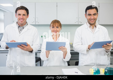 Scientists using tablet PCs in the lab Stock Photo