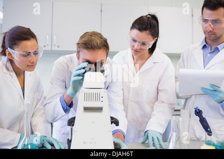 Scientists with microscope in the laboratory Stock Photo