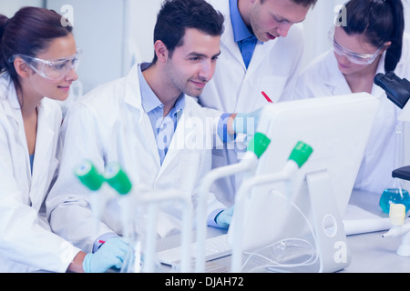 Researchers looking at computer screen in the lab Stock Photo