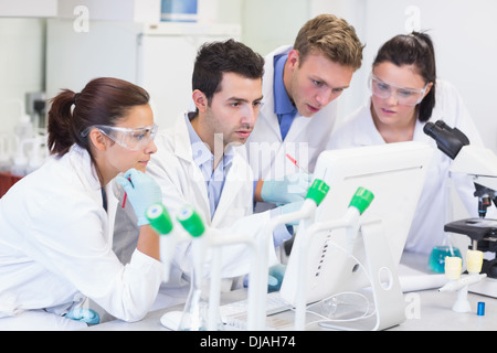 Researchers looking at computer screen in the lab Stock Photo