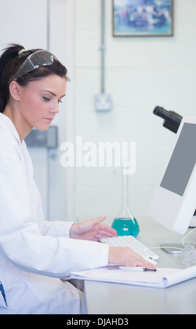 Young female researcher using computer in lab Stock Photo