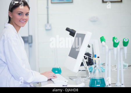 Young female researcher using computer in lab Stock Photo