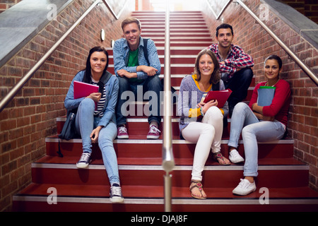 College students sitting on stairs in the college Stock Photo