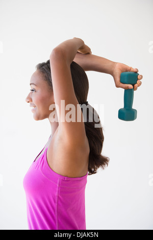 Black woman lifting weights Stock Photo