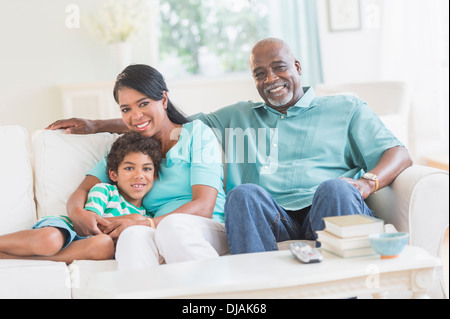 Three generations of family relaxing together Stock Photo