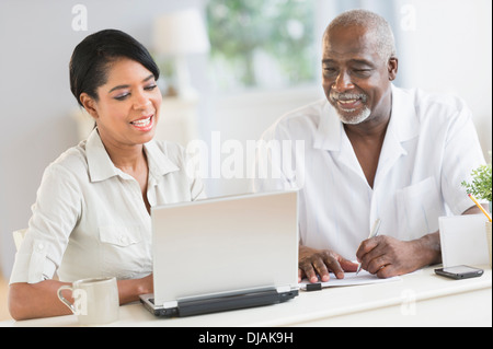 Black father and daughter using laptop Stock Photo
