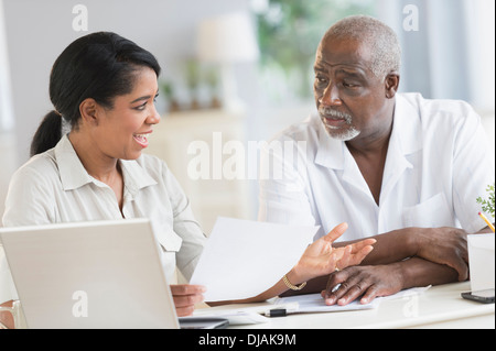 Black father and daughter using laptop Stock Photo