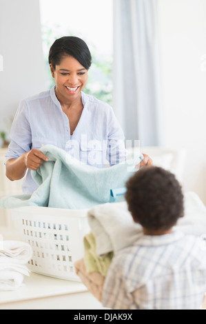 Mother and son folding laundry Stock Photo
