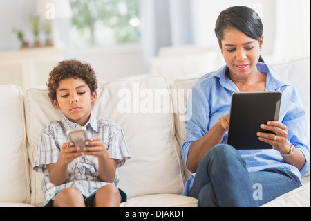 Mother and son relaxing on sofa Stock Photo