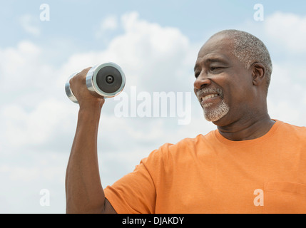 Black man lifting weights outdoors Stock Photo