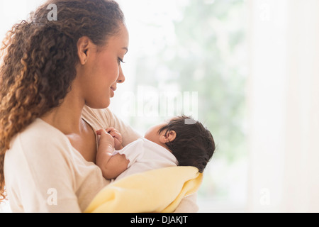Hispanic mother holding newborn baby Stock Photo