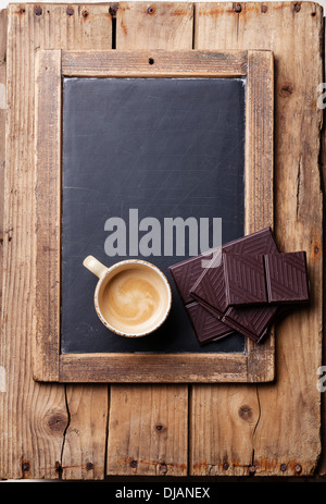Coffee cup with chocolate on vintage slate chalk board Stock Photo