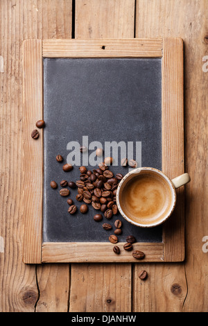 Coffee cup with coffee beans on vintage slate chalk board Stock Photo