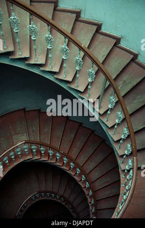 Ancient interior with really old wooden spiral stairs Stock Photo