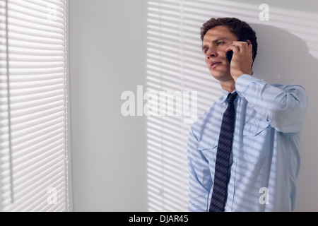 Serious young businessman using mobile phone Stock Photo