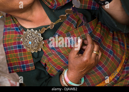 Bhutan, Nobding, woman wearing traditional kira costume with old silver korma brooches decorated with old Indian coins Stock Photo