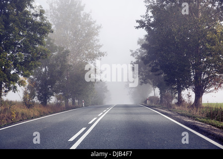 Empty road behind the countryside Stock Photo