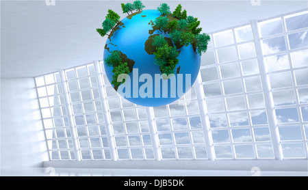 Globe floating in room Stock Photo