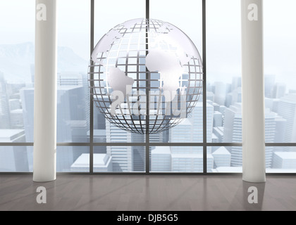 Silver globe floating in room Stock Photo