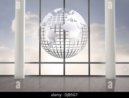 Silver globe floating in room Stock Photo
