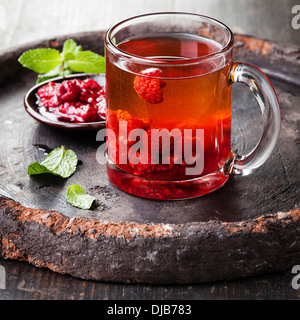 Hot tea with raspberry on dark background Stock Photo