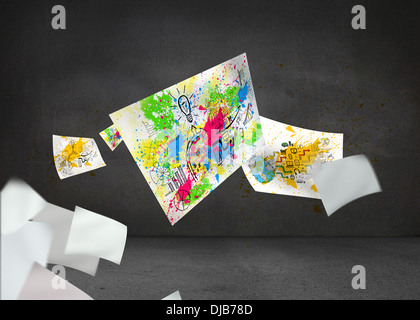 Sheets with graphics and splashes over grey wall Stock Photo