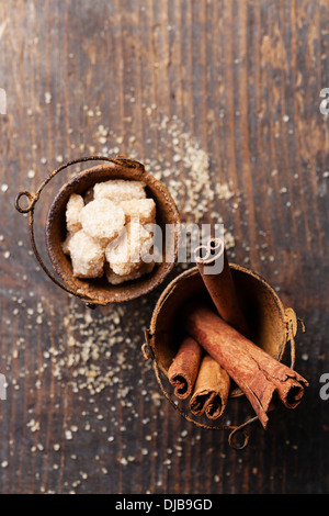 Cinnamon sticks and brown sugar on wooden background Stock Photo