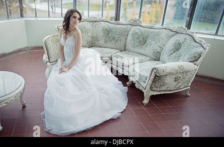 Stressed bride wearing pretty wedding gown Stock Photo