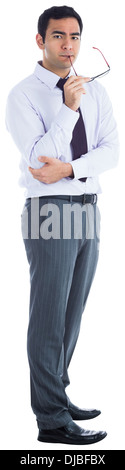 Unsmiling businessman holding glasses Stock Photo