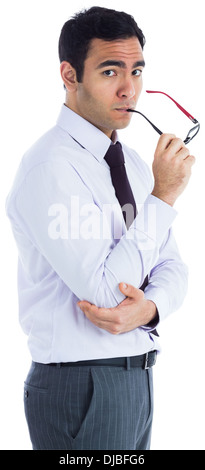Unsmiling businessman holding glasses Stock Photo