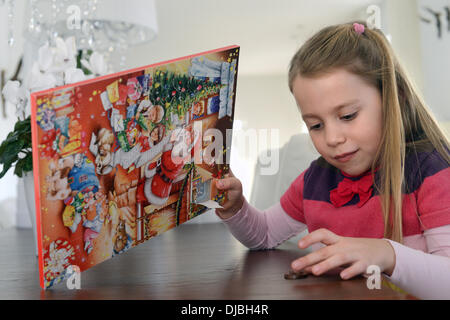 A little girl and her advent calendar. Stock Photo