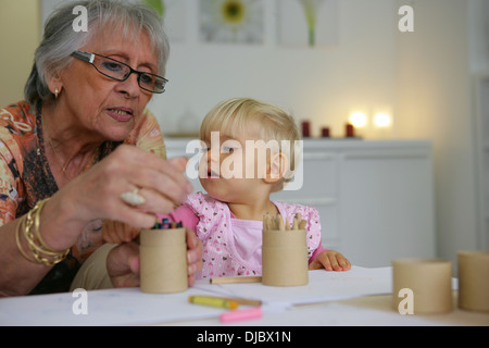 Young child coloring with grandma Stock Photo