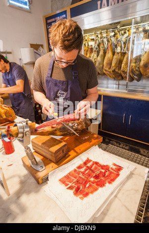 England, London, Southwark, Borough Market, Man Slicing Spanish Ham Stock Photo