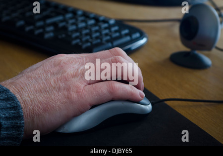 Hand on computer mouse Stock Photo