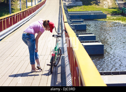 Portrait of pretty young woman with bicycle Stock Photo