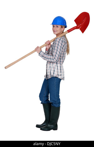 Labourer carrying a spade Stock Photo