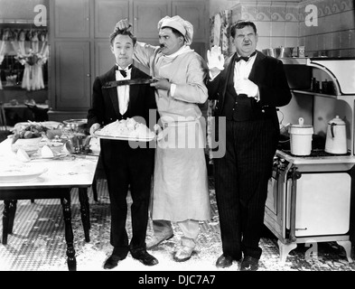 Stan Laurel, Oliver Hardy and Otto Fries on-set of the Film, From Soup to Nuts, 1928 Stock Photo