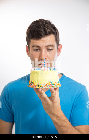 Young man holding a birthday cake Stock Photo